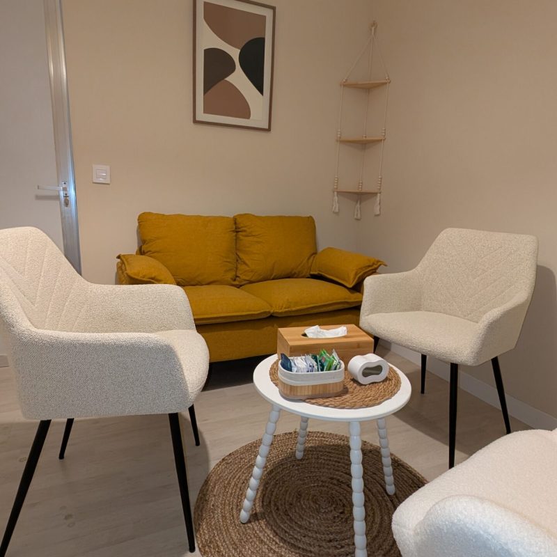 Sala de coworking tranquila y acogedora, un espacio seguro para escucharte en Lekua, perspectiva detalle que muestra sofá, sillas y mesa auxiliar y entrada.